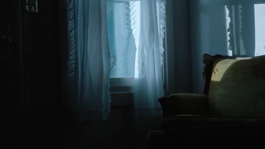 Curtains surrounding a window in a home with passerby's outside