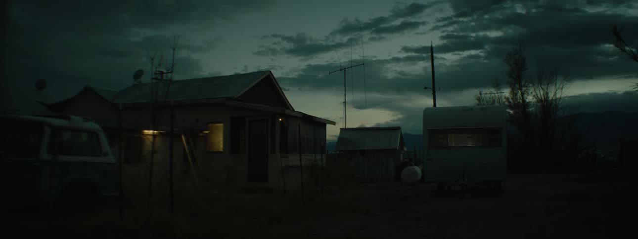 Lights shine in a small house at night