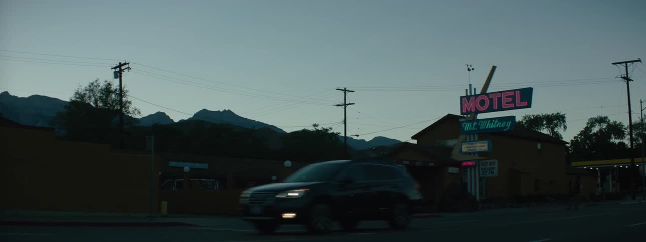 Cars and trucks drive through an intersection