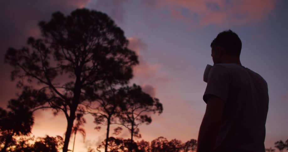A man watches the sunset
