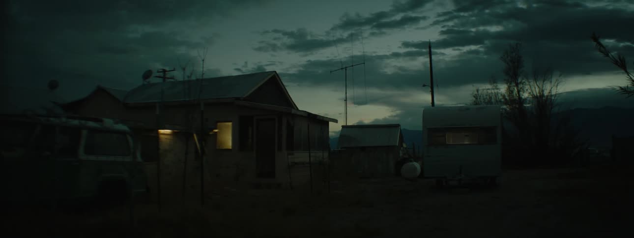 House with lights on inside at sunset