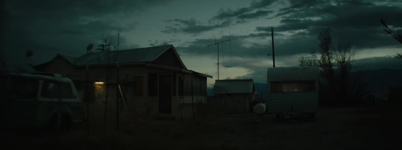 Lights flicker inside a rural home at night