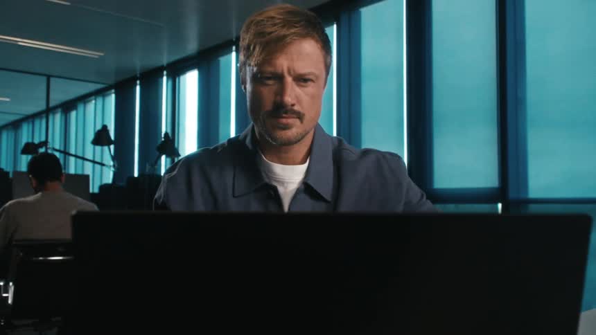 stylish man opens his laptop in a co-working space