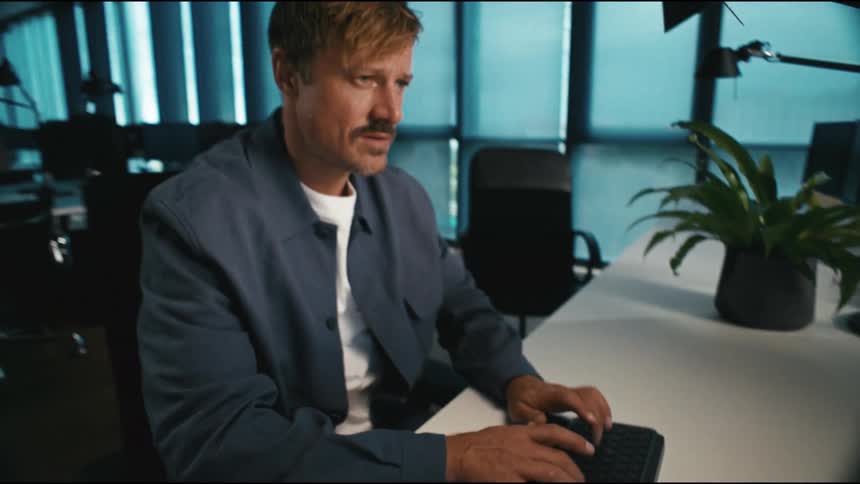 office worker suddenly finds the solution and starts typing frantically