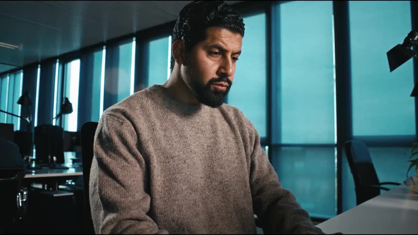 Man opening laptop and starts working focussed in the office