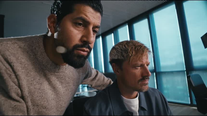 Two men analyzing information on a computer screen