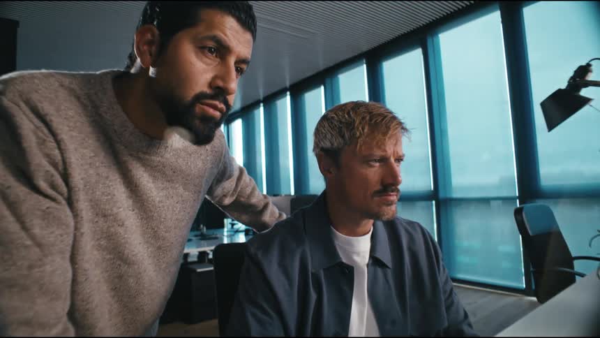 two guys working concentrated on the computer