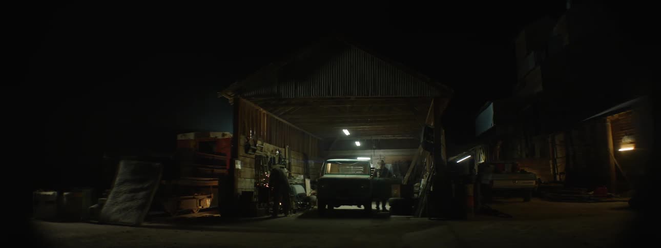 Man welding inside garage at night