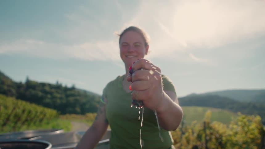 Woman squeezing a bunch of grapes