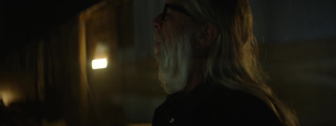 Older man watching as lights flicker in a building