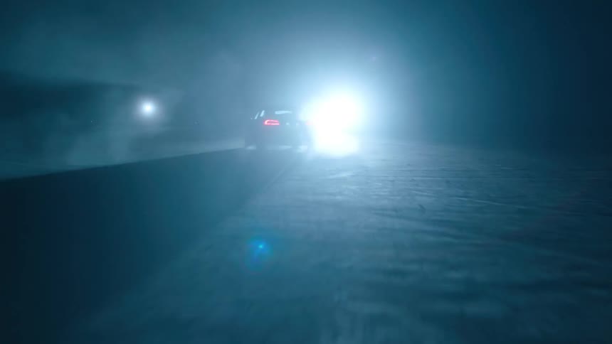 A car makes turns in the dark ahead
