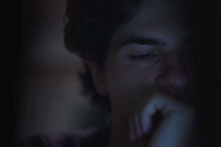 The man is looking at a monitor
