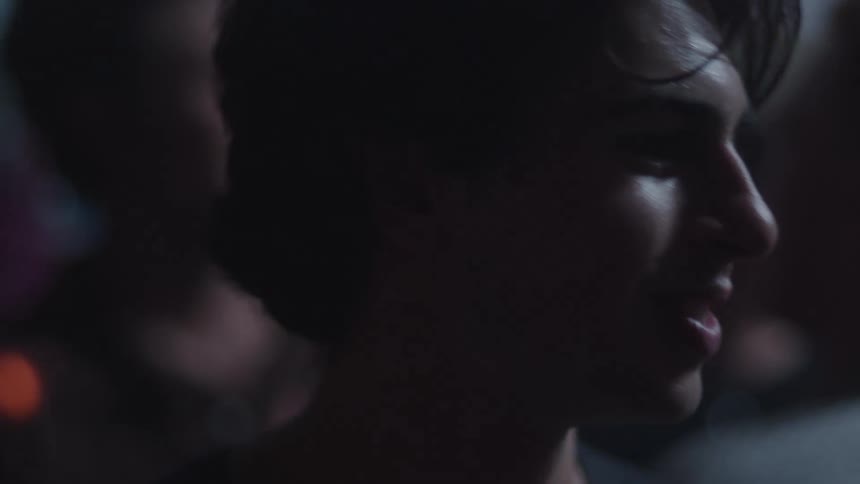 Face lit by soft lights amid a crowd