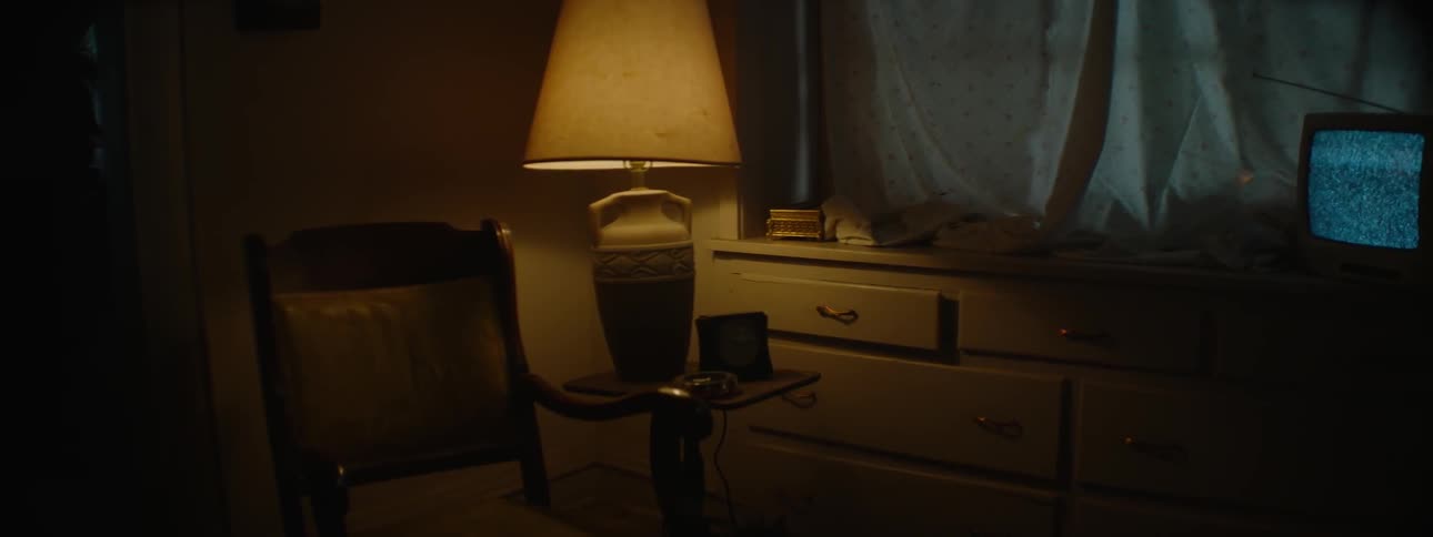 A lamp illuminates a room at night