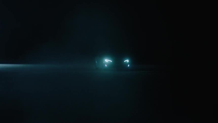 Sports car driving fast in the dark night