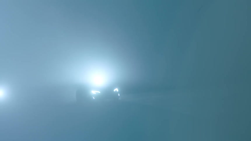Car speeding on pavement at night