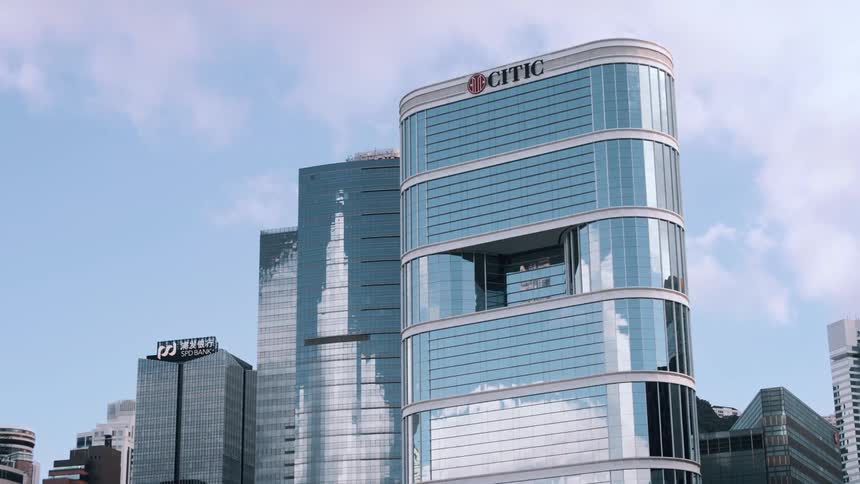 Corporate buildings in hong kong with mirrored facades reflecting the blue sky