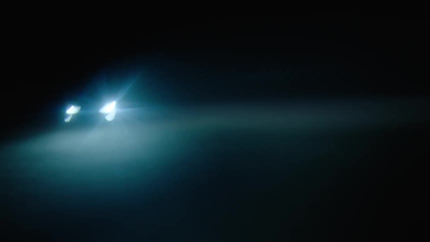 A car driving around at night in a lot