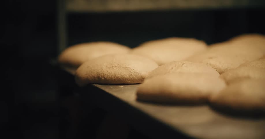 Portions of dough arranged on a tray before baking