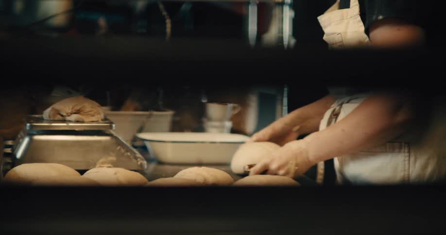 The baker is making bread in the bakery