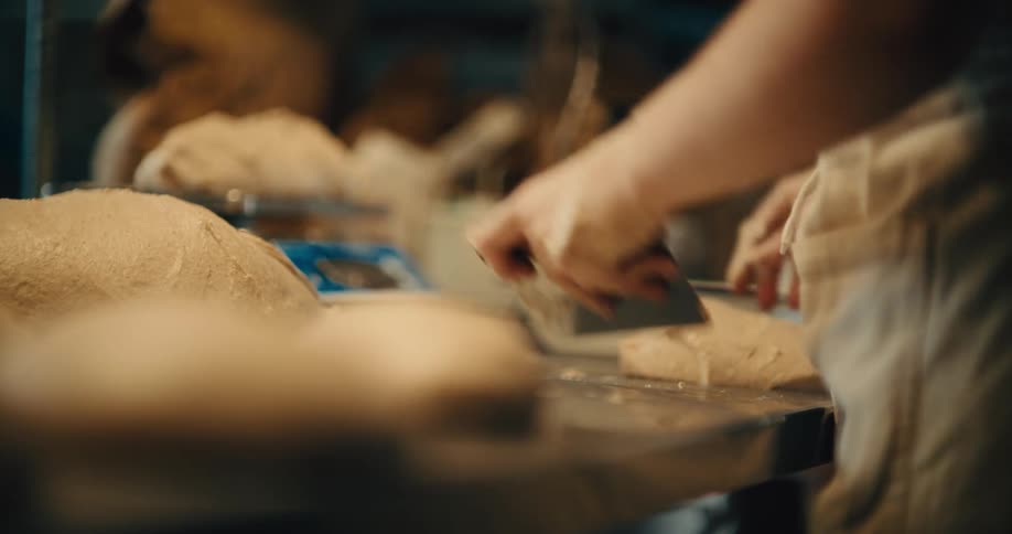 A baker preps dough