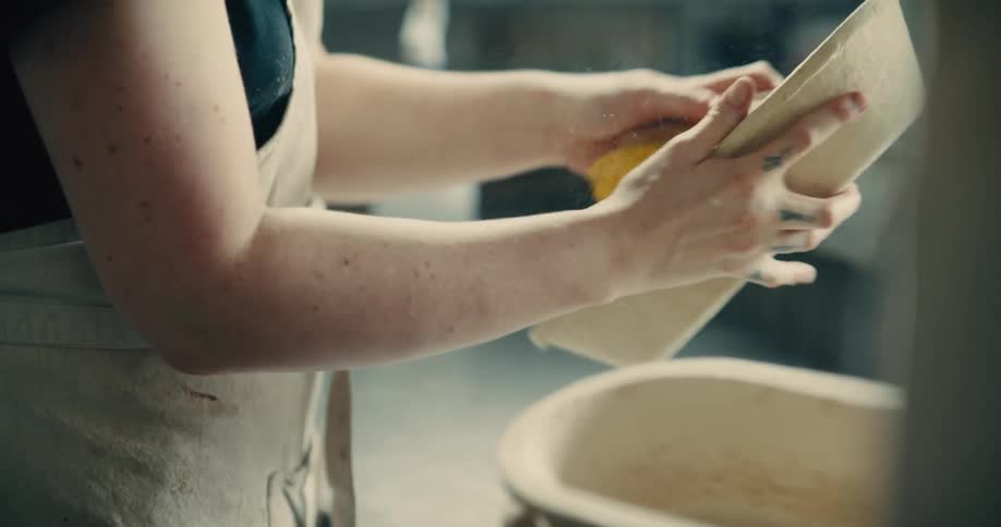 Close up of a young woman cleaning baking containers after use