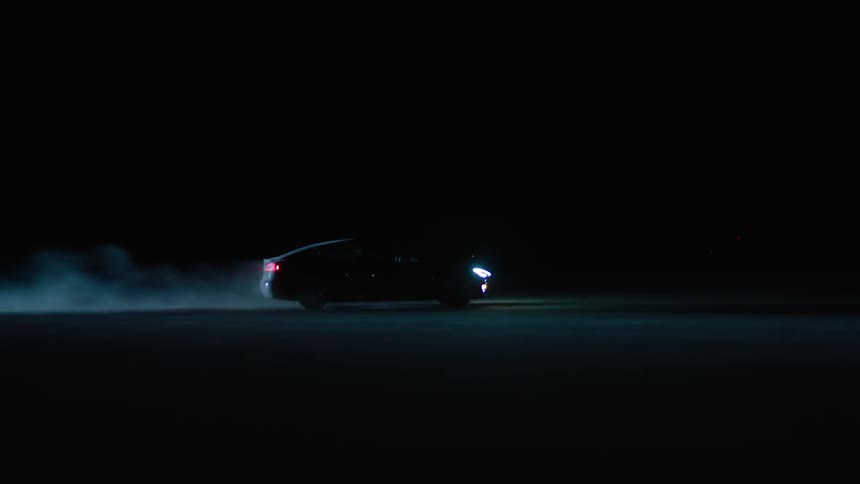 A car is driving at night