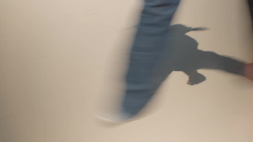 Human legs walking on a sandy ground outdoors during day time