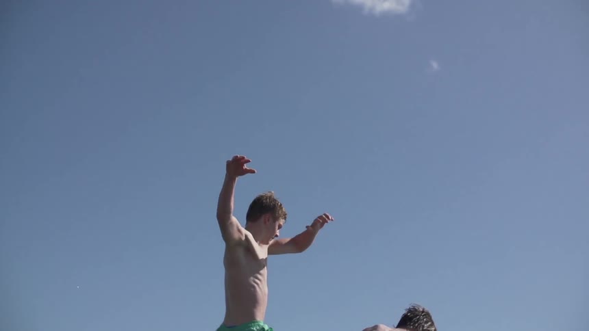 Two men jumping into the water