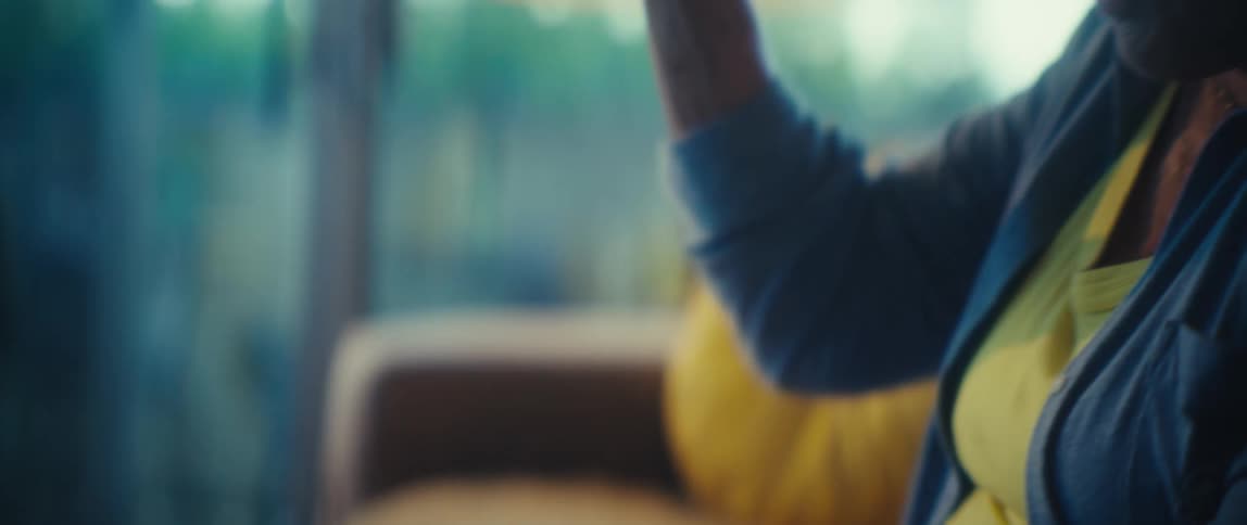 The woman is cheering and waving her hands