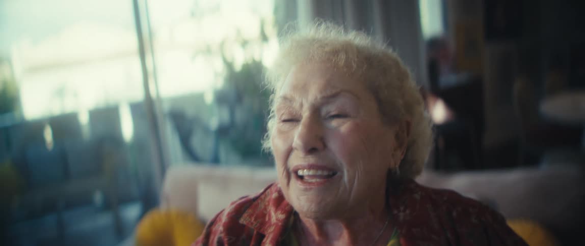 The woman is singing and waving her arm while dancing