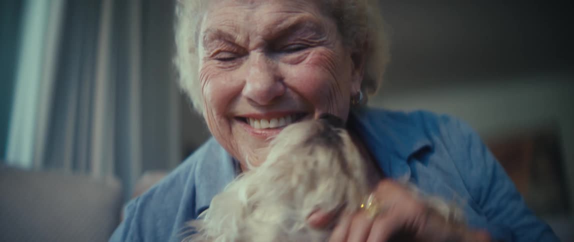 The woman hugs and kisses her dog