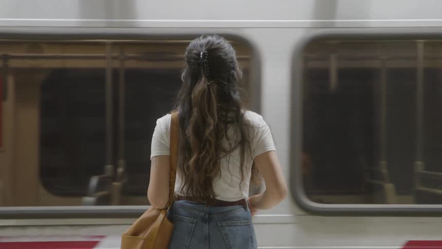 The video clip is an extreme closeup of a persons feet wearing light grey or white socks their feet are propped up on the edge of what appears to be a white bathtub or similar surface