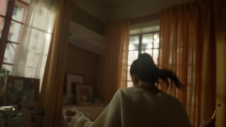 Woman sings and dances while holding a bowl of food in her bedroom