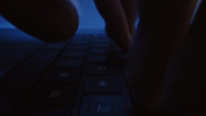 A person rapidly typing on a computer keyboard