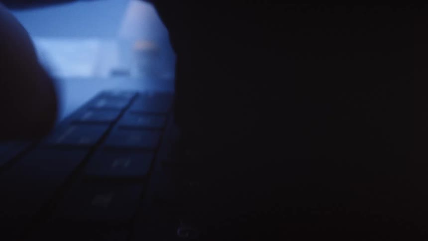 Fingers type on a keyboard