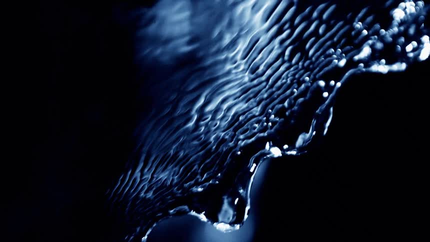 Rippled water surface reflecting blue light in an abstract pattern