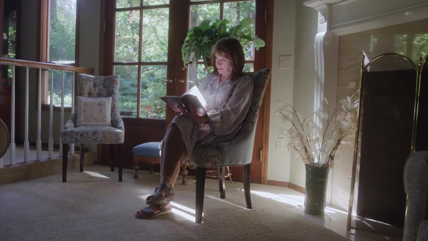 A woman sits and reads