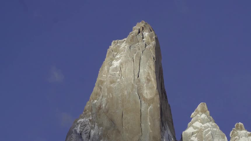 Clouds float over a rocky mountain peak
