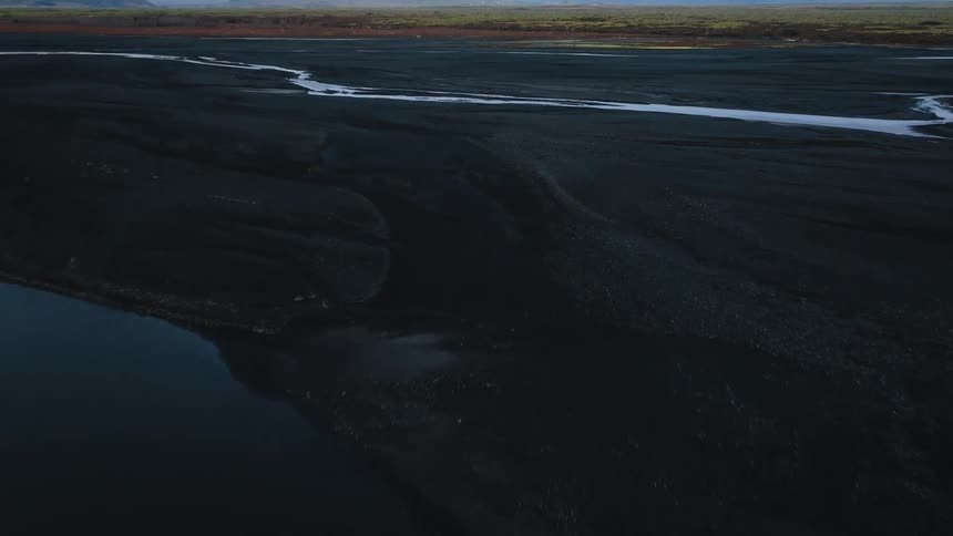 A river winds through a large field