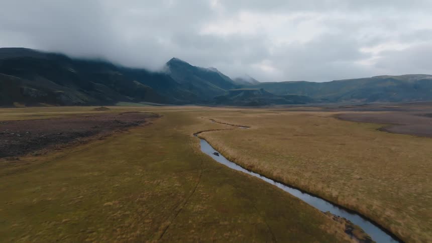 A winding river cuts through a large field