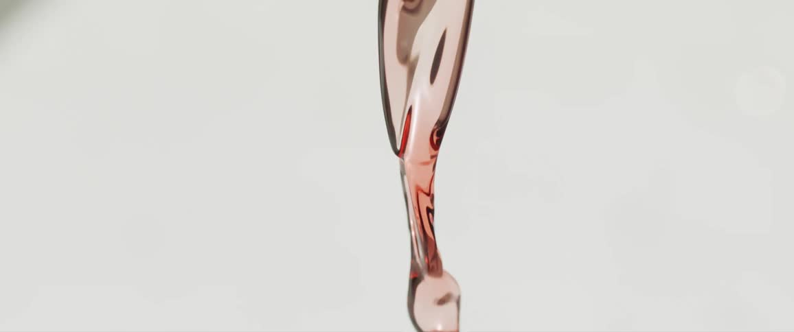 Close up of a red liquid pouring downwards