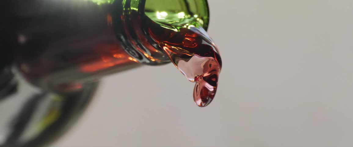 Red wine pours out of a bottle
