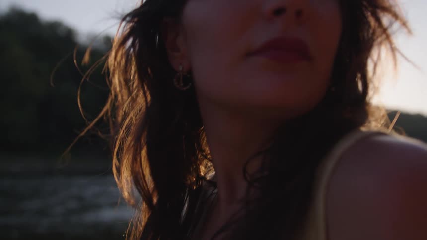 A woman outside by some water