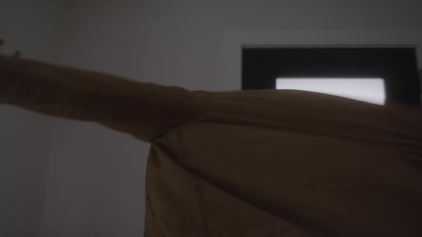 Man putting on his jacket and walking out the door