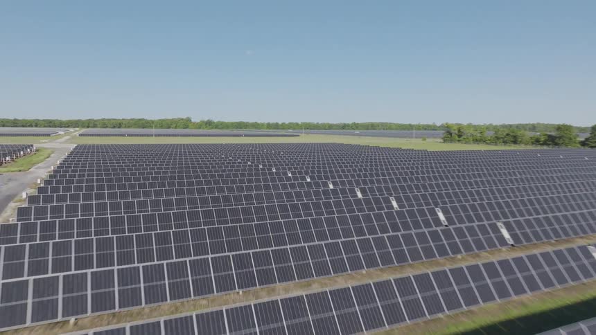The sun is shining on the landscape full of solar panels