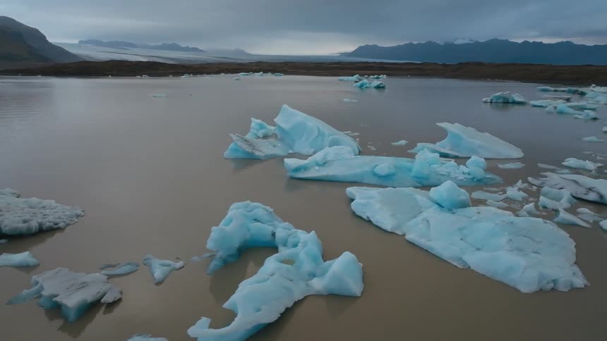 Icebergs floating in the antarctica ocean at dusk