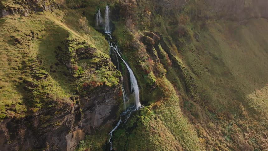 Water cascades down a cliff