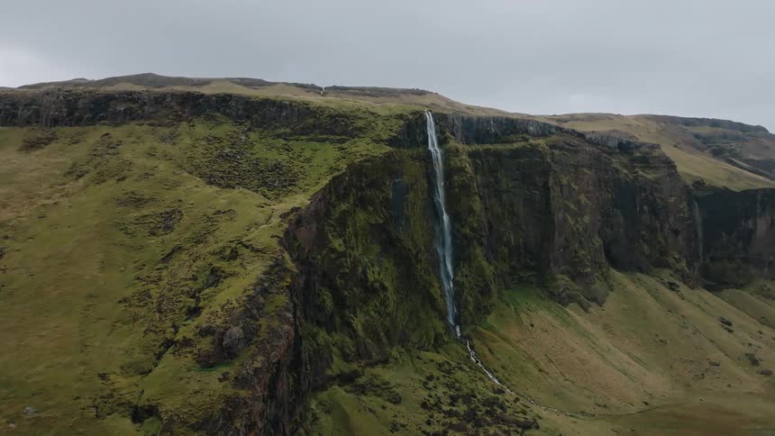 A waterfall cascades down a cliff