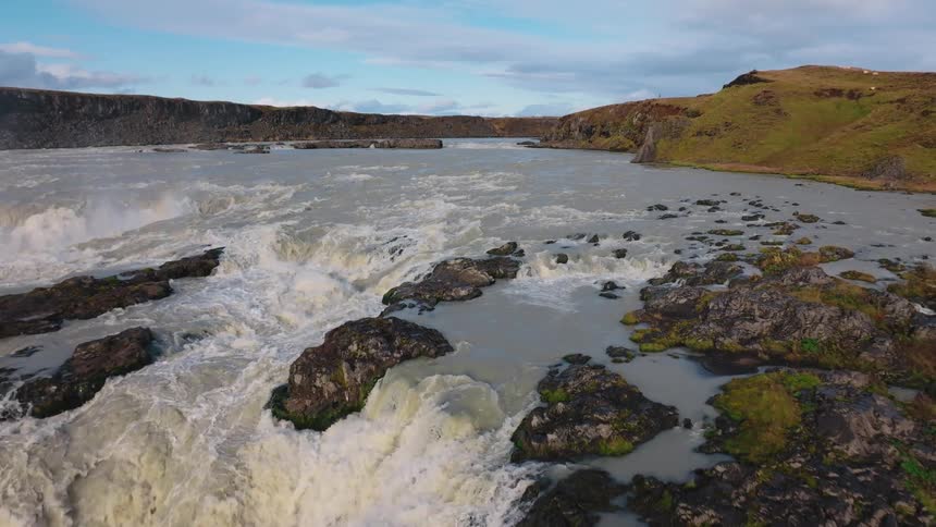 Water rushes down a large river
